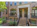 Brick townhome showcases elegant entrances with stone steps and wrought iron accents at 2380 Crescent Park Ct # 4, Atlanta, GA 30339