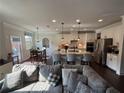 Spacious kitchen with a center island, white cabinetry, stainless steel appliances, and pendant lighting at 442 Snow Owl Way, Lawrenceville, GA 30044