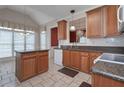 Traditional kitchen features a center island, granite countertops, and wooden cabinets at 1239 Brentwood Ct, Douglasville, GA 30135