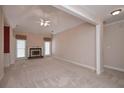 Spacious living room with plush carpeting, fireplace, and natural light from large windows at 1239 Brentwood Ct, Douglasville, GA 30135