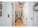 Bright hallway with light wood floors and white walls, with a view of the front door at the end at 493 Whaleys Lake Dr, Jonesboro, GA 30238