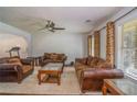 Cozy living room with a ceiling fan, hardwood floors, neutral paint and comfortable leather furniture at 493 Whaleys Lake Dr, Jonesboro, GA 30238