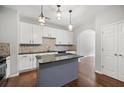 Bright kitchen featuring granite countertops and a central island at 1239 Grampian Pass # 11, Marietta, GA 30008