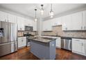 Modern kitchen with stainless steel appliances, island and stylish backsplash at 1239 Grampian Pass # 11, Marietta, GA 30008