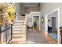 Bright foyer boasts wood floors, staircase to the second level, and entry to various rooms at 220 Webley Ln, Alpharetta, GA 30022