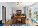 Well-lit home office featuring hardwood floors, large windows, and a built-in bookcase at 220 Webley Ln, Alpharetta, GA 30022