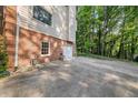 Exterior shot with a brick wall next to a driveway with a garage in the background at 127 Roe Hampton Ln Ln, Stone Mountain, GA 30087