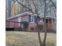 Brick home featuring a side deck and mature trees at 2289 Addison Rd, Marietta, GA 30066