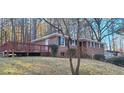Brick home featuring a side deck and mature trees at 2289 Addison Rd, Marietta, GA 30066