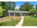 Cozy home with a tidy front lawn and a welcoming walkway at 3131 Garden Lane Dr, Marietta, GA 30062