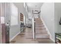 Bright foyer featuring a staircase, light wood floors, and ample natural light from tall windows at 930 Silver Lake Dr, Acworth, GA 30102