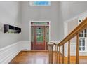 Open foyer with hardwood floors, high ceilings, and decorative front door at 11575 Wildwood Springs Dr, Roswell, GA 30075