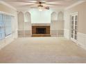 Spacious living room with built-in shelving, a brick fireplace, and bright natural light at 11575 Wildwood Springs Dr, Roswell, GA 30075