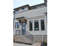 Charming townhouse entrance with brick stairs, black railing, and stylish front door at 293 White St # 2, Marietta, GA 30060