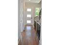 Bright hallway features wood floors, staircase with iron railings and a modern front door at 293 White St # 2, Marietta, GA 30060