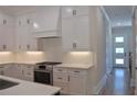 Modern kitchen features white cabinets, stainless appliances, and an open view to the hallway at 293 White St # 2, Marietta, GA 30060