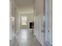 Bright foyer featuring wood-look floors, classic trim and a view to a fireplace at 308 Delta Dr, Mcdonough, GA 30253