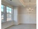 Open living space with bright windows, stylish chandelier, and decorative wall trim at 308 Delta Dr, Mcdonough, GA 30253