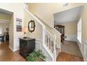 Bright foyer showcasing staircase, decor table, and adjacent dining area at 516 Huntgate Rd, Woodstock, GA 30189