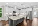 Modern kitchen with stainless steel appliances, an island, and ample cabinet space at 2335 Plummer Sw Pl, Marietta, GA 30064