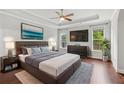 Spacious main bedroom featuring hardwood floors, a ceiling fan, and windows at 2335 Plummer Sw Pl, Marietta, GA 30064