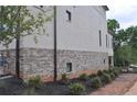 View of townhome brick and siding with foundation landscaping at 289 White St # 3, Marietta, GA 30060