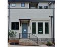 Close up on townhome exterior with blue door and brick stairway and base at 289 White St # 3, Marietta, GA 30060