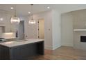 Bright kitchen showcasing a large island, modern lighting, and stainless steel appliances at 289 White St # 3, Marietta, GA 30060