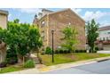 Rear view of a brick townhome with manicured lawn and shrubbery at 4202 Morrison Way # 9, Atlanta, GA 30341