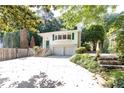 Charming white home with green shutters, lush landscaping and a large driveway at 746 Gladstone Nw Rd, Atlanta, GA 30318