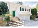 Two-story white home featuring a green front door and a two-car garage at 746 Gladstone Nw Rd, Atlanta, GA 30318