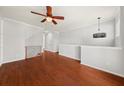 Spacious living area with hardwood floors, neutral paint and trim, and modern light fixture at 1168 Liberty Nw Pkwy, Atlanta, GA 30318
