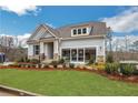 Charming home featuring stone accents, a covered front porch, and professional landscaping at 159 Sunshower Rdg, Canton, GA 30114