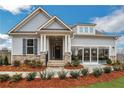 Beautiful home with stone accents, covered porch, and a unique multi-panel garage door at 159 Sunshower Rdg, Canton, GA 30114