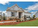 Attractive home with stone accents, a covered porch, and a garage with glass panels at 159 Sunshower Rdg, Canton, GA 30114