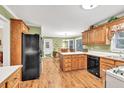 Efficient kitchen featuring wood cabinets, functional island and adjacent dining area at 241 Tweed Ct, Sugar Hill, GA 30518