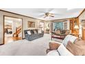 Cozy living room with plush seating, fireplace, and lots of natural light at 241 Tweed Ct, Sugar Hill, GA 30518