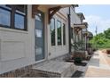 Townhouse exterior showing brick steps, neutral paint, trimmed windows, and covered entry with wood corbels at 285 White St # 4, Marietta, GA 30060