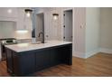 Modern kitchen featuring an island, stainless steel appliances, and white cabinetry with a subway tile backsplash at 285 White St # 4, Marietta, GA 30060