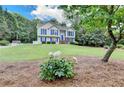 Beautiful home with a lush green lawn and garden with white flowers at 1818 Mcconnell Rd, Grayson, GA 30017