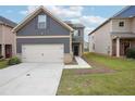 Charming two-story home with a two car garage, landscaped front yard and craftsman style accents at 2493 Oakleaf Rdg, Lithonia, GA 30058