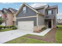 Charming two-story home with a two car garage, landscaped front yard and craftsman style accents at 2493 Oakleaf Rdg, Lithonia, GA 30058
