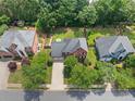 Aerial view of a neighborhood with mature trees and well-manicured lawns showcasing this community's attractive curb appeal at 530 Summerhill Dr, Roswell, GA 30075