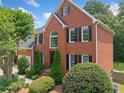 Charming two-story brick home featuring manicured landscaping and a classic architectural design at 530 Summerhill Dr, Roswell, GA 30075