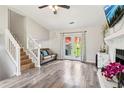 Bright living room with wood floors, fireplace, and access to the backyard through French doors at 1126 Mainstreet Valley Dr, Stone Mountain, GA 30088
