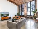 Spacious living room with high ceilings, large windows, hardwood floors, and modern furnishings at 170 Boulevard Se # E117, Atlanta, GA 30312