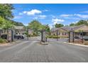 Gated community entrance with brick pillars and wrought iron at 1705 Brighton Pt, Atlanta, GA 30328