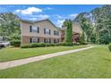 The exterior of the property has manicured green lawn and mature trees surrounding the home at 1705 Brighton Pt, Atlanta, GA 30328