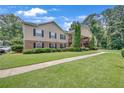 Beautiful condo building with manicured lawn, mature trees, and stone accents at 1705 Brighton Pt, Atlanta, GA 30328