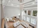 Grand living room showcasing high ceilings, a modern chandelier, and abundant natural light at 3423 Jamont Blvd, Alpharetta, GA 30022